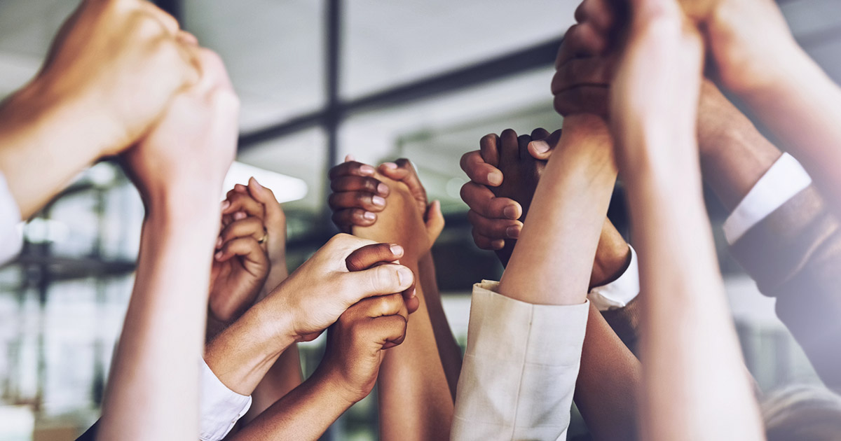 Cropped shot of a group of business people holding hands