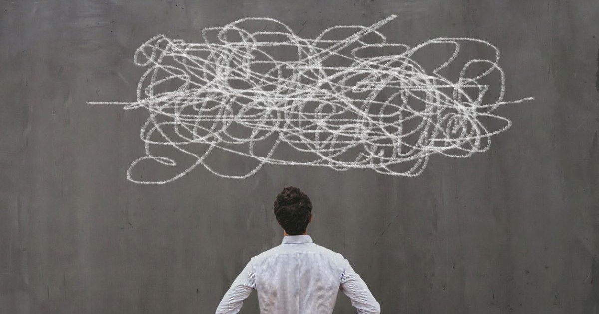 A man looking up at scribbles on a wall