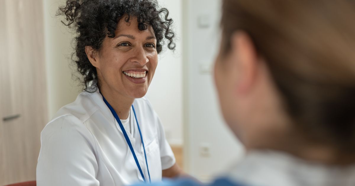 a woman smiling at another woman