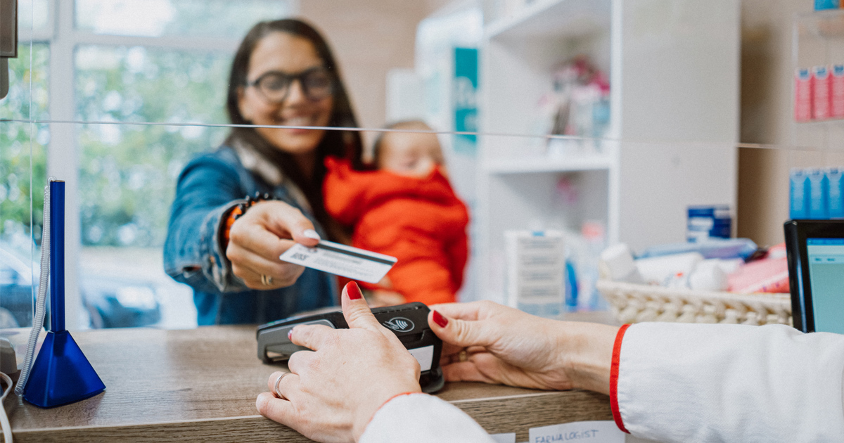 A woman presents a credit card for a purchase.