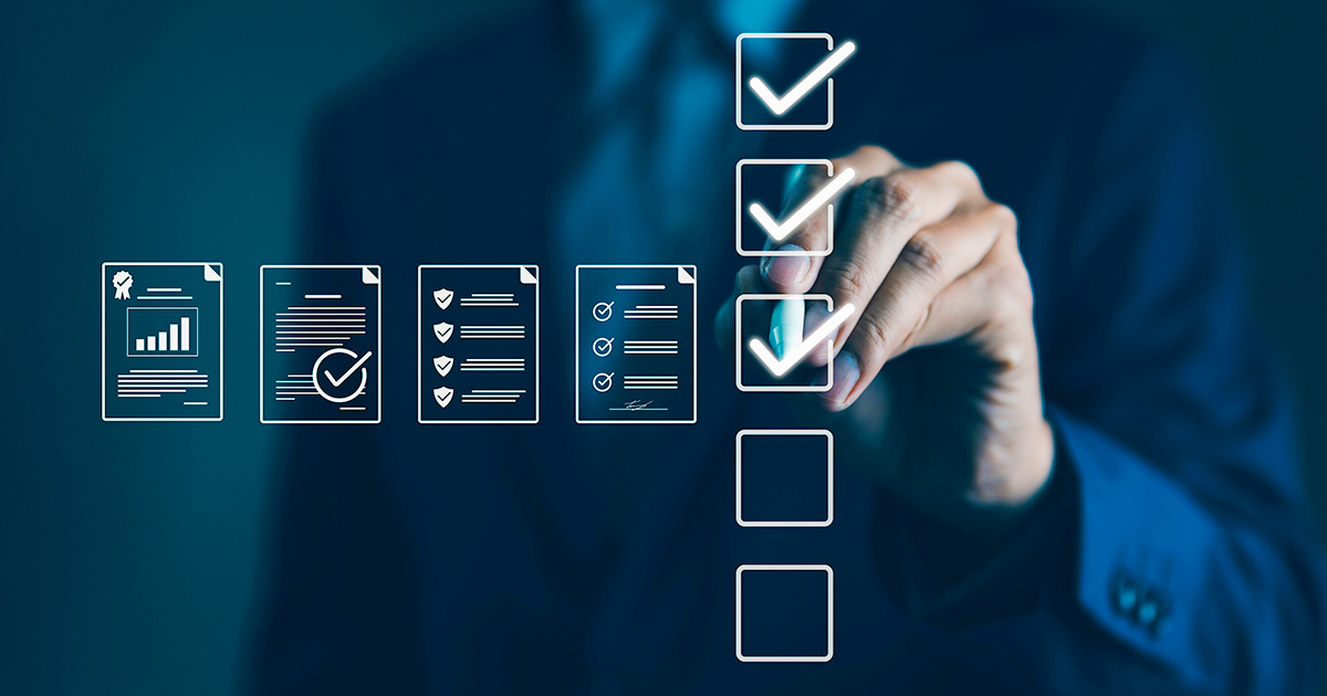 Businessman mark off items on digital checklist, representing quality assurance and document control processes, verification and compliance.